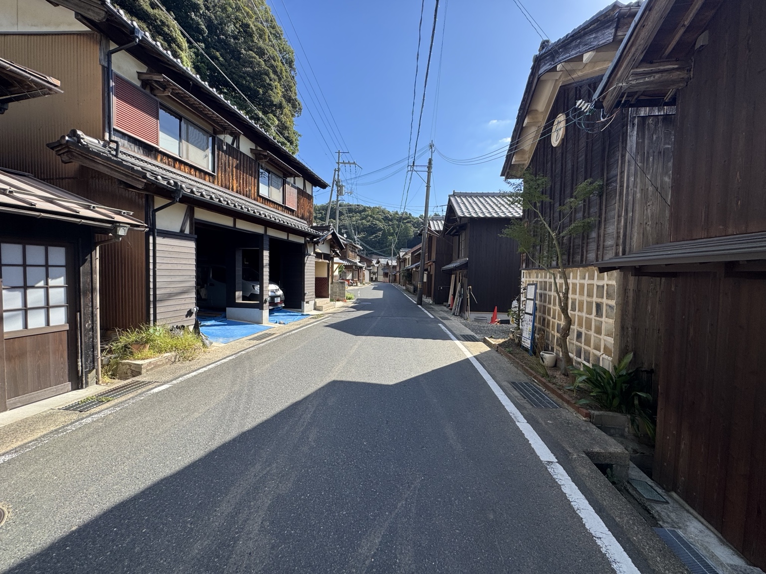 A narrow street between timber houses in the coastal town